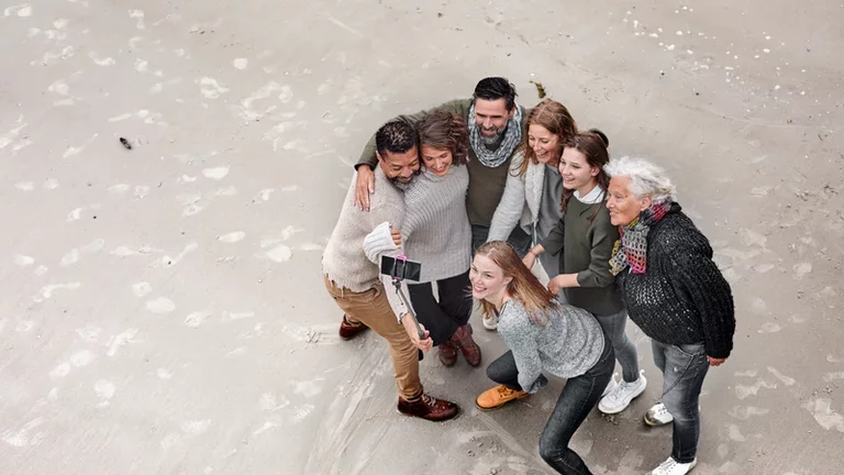 People taking a selfie on the beach